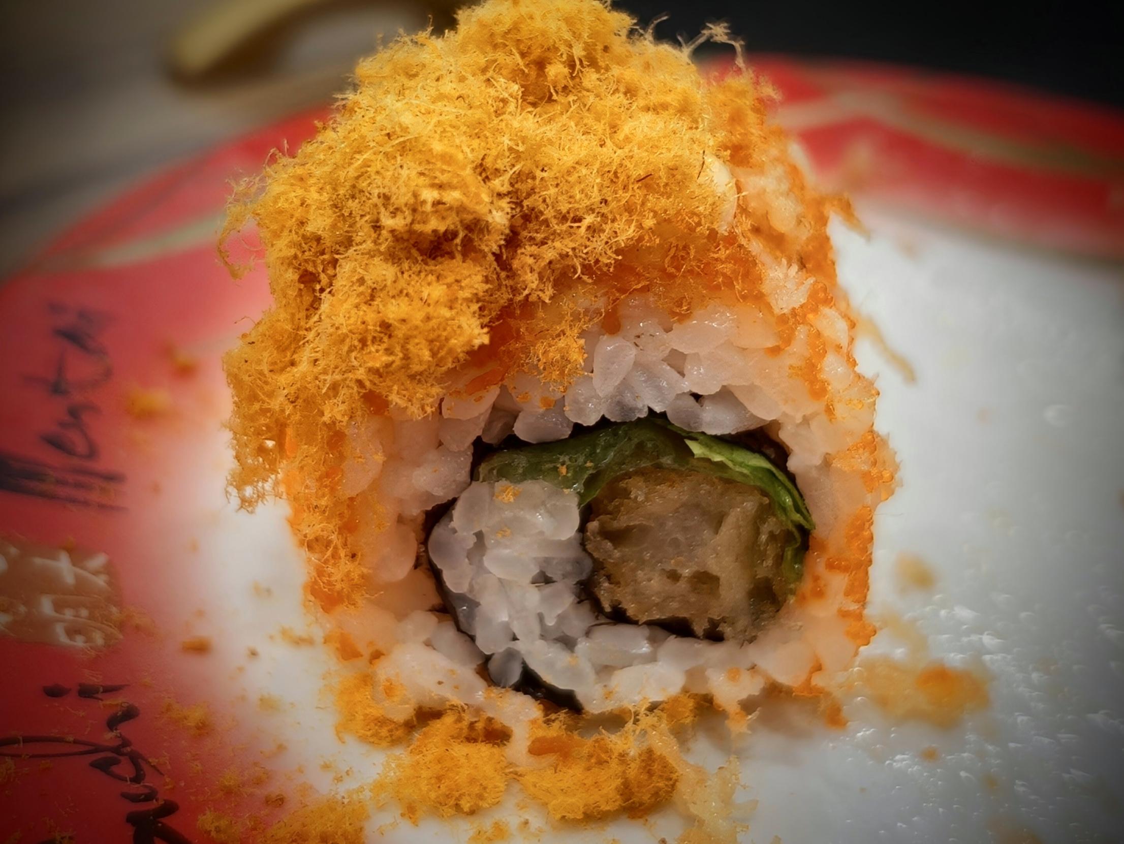 Cross-section of a prawn-fry roll heaped with floss and tobiko
